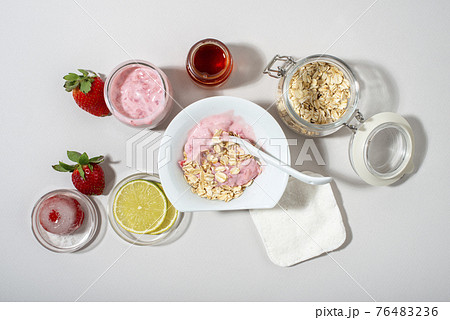Homemade strawberry face mask ingredients: strawberry, yoghurt, honey, lemon, oatmeal. 76483236