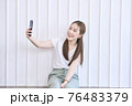 Closeup portrait of Asian lady smile and taking selfie at her home. Concept woman lifestyle 76483379