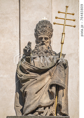 Ancient decorative top facade statues of priests, bishops at Saint Salvator church near Charles Bridge in Prague, Czech Republic, details, closeup 76483809