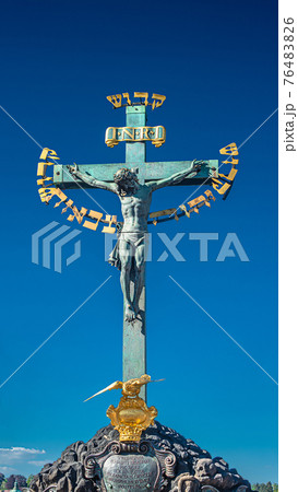 Statue of Crucifixion of Jesus at the Charles Bridge in Prague, Czech Republic 76483826