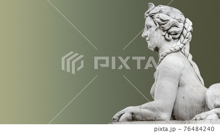 Statue of beautiful mysterious sphinx in downtown of Potsdam isolated at smooth even green background, Germany 76484240