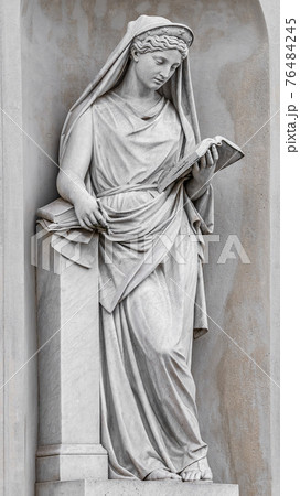 Ancient statue of sensual Italian Renaissance Era woman reading a book, Potsdam, Germany, details, closeup 76484245