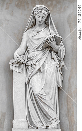 Ancient statue of sensual Italian Renaissance Era woman reading a book, Potsdam, Germany, details, closeup 76484246