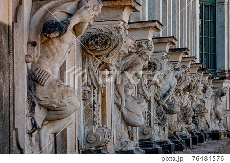 Row of old mythological and religious statues in the Zwinger palace and garden in downtown of Dresden, Germany 76484576