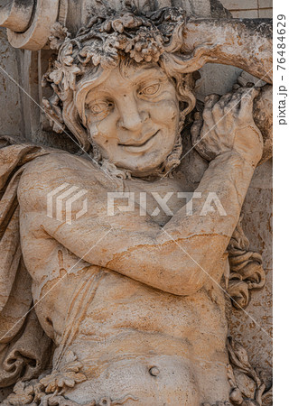 Old sculpture of funny and joyful dickens in downtown of Dresden, Germany, details, closeup 76484629