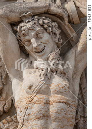 Old sculpture of funny and joyful dickens in downtown of Dresden, Germany, details, closeup 76484631