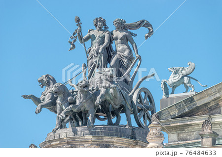 Old statue of Dionis and Aridna quadriga with four panthers on the top of the State Opera House in downtown of Dresden, Germany, details, closeup Old statue of Dionis and Aridna quadriga with four panthers on the top of the State Opera House in downtown of Dresden, Germany, details, closeup 76484633