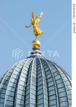 Old statue of a golden angel as a warrior and defender at the dome top of the central historical building Zitronenpresse in downtown of Dresden, Germany, details 76484646