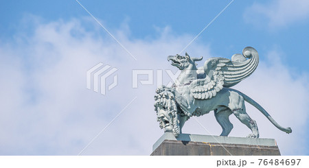 Banner with old statue of medieval griffin, a hybrid of lion and bird, on the top of the State Opera House in downtown of Dresden, Germany, details, closeup, with copy space for text. 76484697