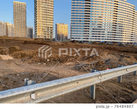 Construction industrial work on the road and a large metal bumper for road safety Construction industrial work on the road and a large metal bumper for road safety 76484807