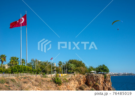 Bird view of Antalya and Mediterranean seacoast and beach with a paraglider and Turkish flag, Antalya, Turkey, Bird view of Antalya and Mediterranean seacoast and beach with a paraglider and Turkish flag, Antalya, Turkey, 76485019