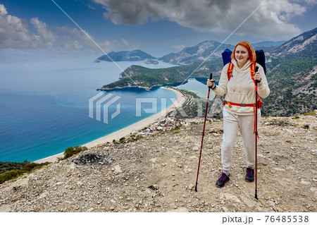 Young woman walks Lycian way near Blue Lagoon in Oludeniz, Turkey. Young woman walks Lycian way near Blue Lagoon in Oludeniz, Turkey. 76485538