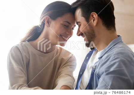 Close up of happy couple lovers hugging Close up of happy couple lovers hugging 76486174