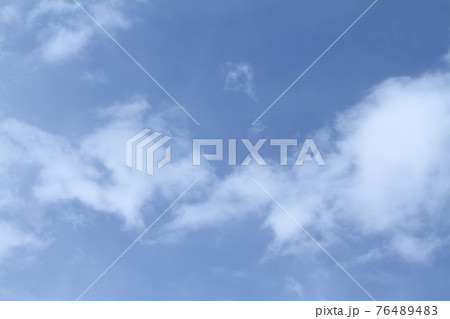 Beautiful blue sky and white clouds of various shapes with sunlight Nature background 76489483