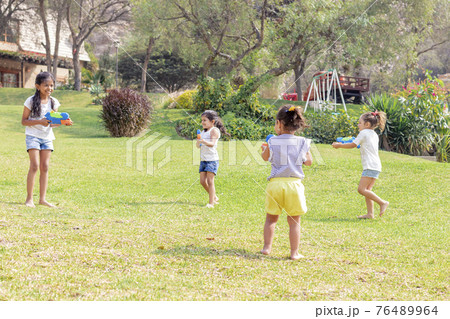 Little girls playing with water in the summer Little girls playing with water in the summer 76489964