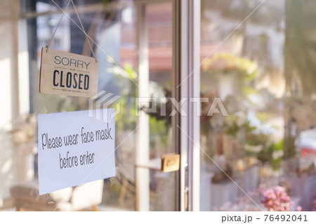 Sorry we are closed wood sign and Please wear face mask befor enter paper on glass door Protection to pandemic of coronavirus. Close store,restaurant due to lockdown quarantine of covid-19. Sorry we are closed wood sign and Please wear face mask befor enter paper on glass door Protection to pandemic of coronavirus. Close store,restaurant due to lockdown quarantine of covid-19. 76492041