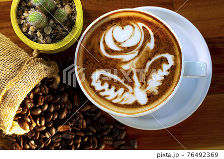 cup of hot coffee on a dark background 76492369