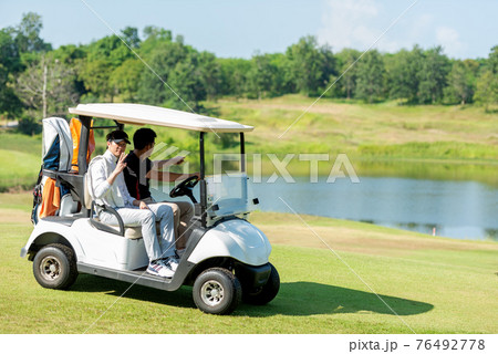 Group Golfer asian man and friend sitting on the car golf go to golf course shot continue game Group Golfer asian man and friend sitting on the car golf go to golf course shot continue game 76492778