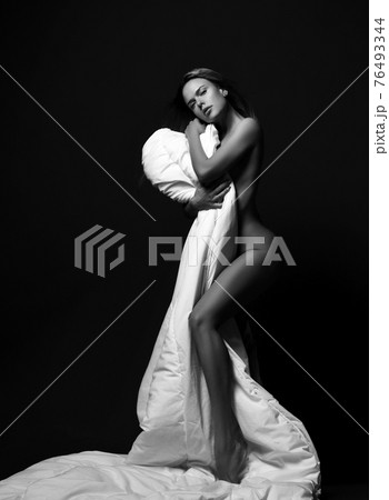 Black and white. Young sexy naked woman stands Black and white. Young sexy naked woman stands 76493344