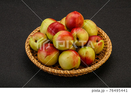 Sweet small nectarines in the basket Sweet small nectarines in the basket 76495441