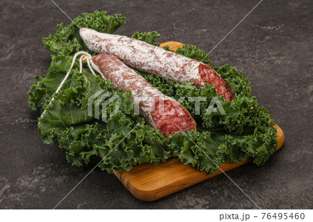 Spanish Fuet sausage with salad leaves 76495460