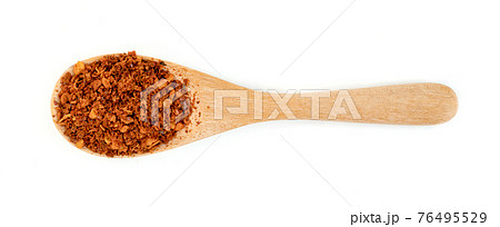red ground paprika powder or dry chili pepper with wooden spoon isolated on white background 76495529