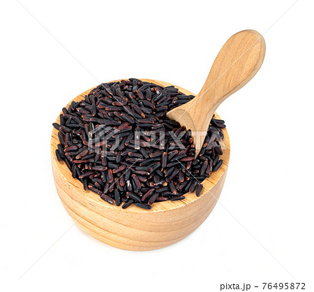 dark violet rice berry with wooden bowl and spoon isolated on white background 76495872