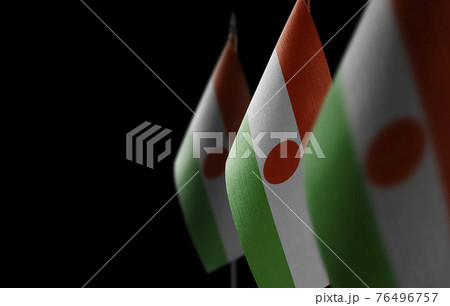 Small national flags of the Niger on a black background 76496757