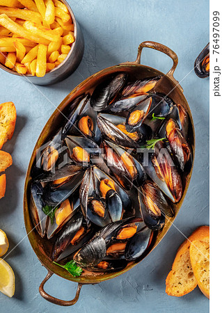 Moules frites, Belgian mussels with French fries Moules frites, Belgian mussels with French fries 76497099