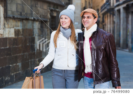 male and female in the historic center with baggage male and female in the historic center with baggage 76499080