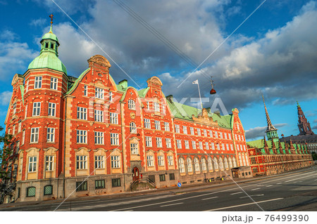 Old stock exchange illuminated in early morning, Copenhagen, Denmark 76499390