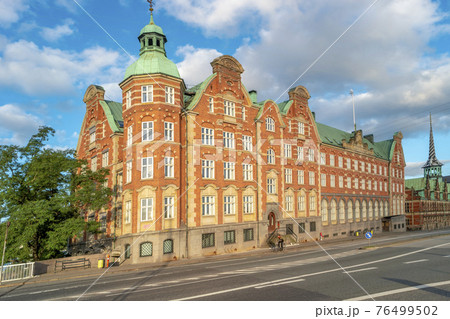 Old stock exchange building illuminated by sunrise in early morning, Copenhagen, Denmark, summer time, paste space 76499502