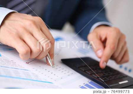 Black calculator and financial statistics on infographics Black calculator and financial statistics on infographics 76499773