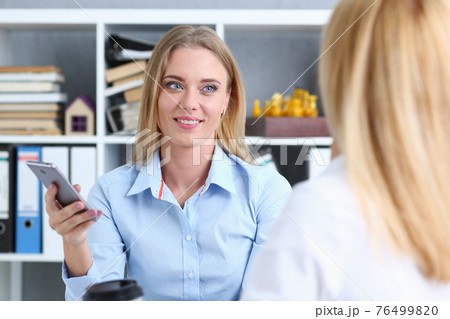 Group of people sit in office deliberate on problem 76499820