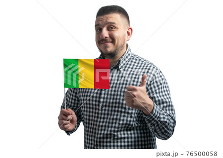 White guy holding a flag of Mali and shows the class by hand isolated on a white background. Like for Mali White guy holding a flag of Mali and shows the class by hand isolated on a white background. Like for Mali 76500058
