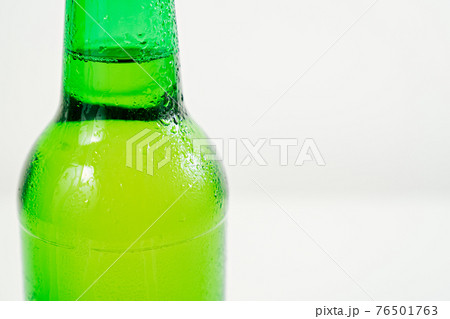 green glass bottle covered with water drops. condensate green glass bottle covered with water drops. condensate 76501763