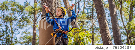 BANNER, LONG FORMAT Happy child in a helmet, healthy teenager school boy enjoying activity in a climbing adventure park on a summer day BANNER, LONG FORMAT Happy child in a helmet, healthy teenager school boy enjoying activity in a climbing adventure park on a summer day 76504287