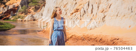 Woman tourist on the Fairy stream among the red dunes, Muine, Vietnam. Vietnam opens borders after quarantine COVID 19 BANNER, LONG FORMAT 76504463