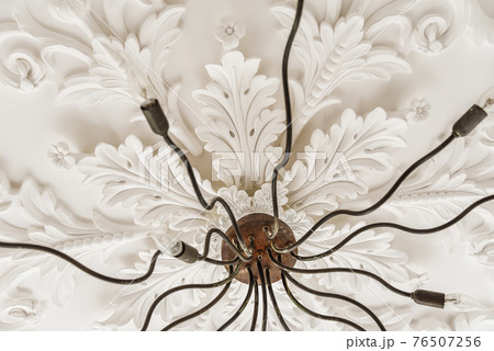 Stucco ornament above elegant chandelier Stucco ornament above elegant chandelier 76507256