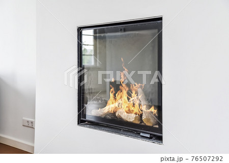 Modern fireplace in white wall Modern fireplace in white wall 76507292