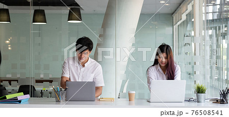 Two business people working with laptop computer at modern office Two business people working with laptop computer at modern office 76508541