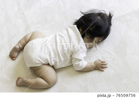 うつ伏せで寝る赤ちゃん 0歳 生後9か月 日本人 女の子 の写真素材
