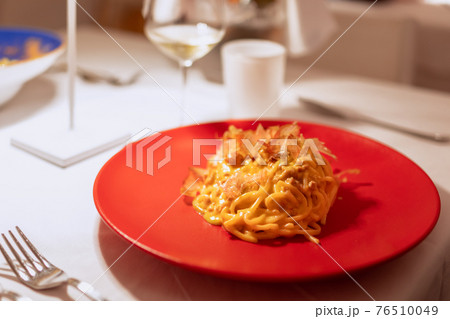 Homemade pasta with fish sauce and tuna flakes. Modern Italian recipe Homemade pasta with fish sauce and tuna flakes. Modern Italian recipe 76510049