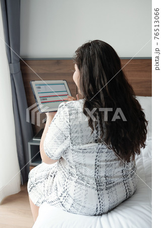 Woman booking ticket online 76513066