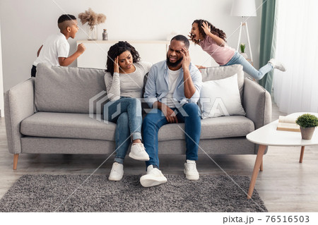 Noisy black children fighting over their shocked parents Noisy black children fighting over their shocked parents 76516503
