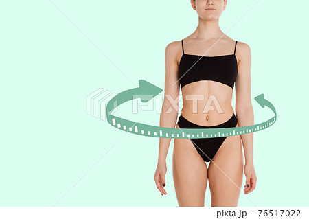 Beautiful slim tanned wonan in black underwear isolated over light background. Beautiful slim tanned wonan in black underwear isolated over light background. 76517022