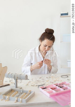 Professional jewelry designer making handmade jewelry in studio workshop. Fashion, creativity and handmade concept Professional jewelry designer making handmade jewelry in studio workshop. Fashion, creativity and handmade concept 76519089