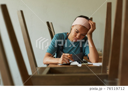 Small Business Owner doing Taxes 76519712