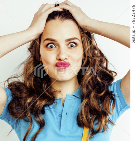 young pretty teenage hipster girl posing emotional happy smiling on white background, lifestyle people concept closeup young pretty teenage hipster girl posing emotional happy smiling on white background, lifestyle people concept closeup 76522476