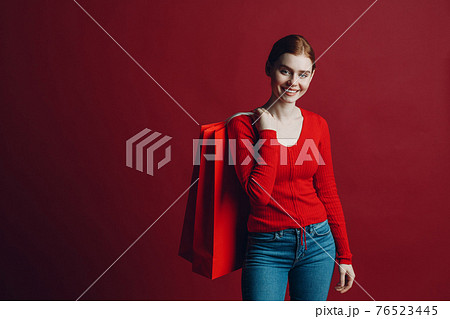 Pretty woman smilng portrait with paper red shopping bags. Black friday and sale. Pretty woman smilng portrait with paper red shopping bags. Black friday and sale. 76523445